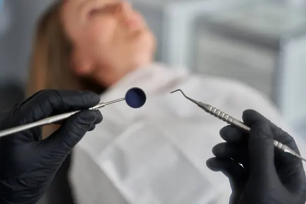 Zahnarzt Hält Zahnärztliches Gerät Über Den Patienten Stockbild