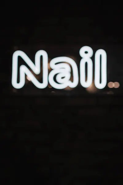 Wow. Neon electricity fluorescent sign nail concept illuminated vintage retro club. Glow icon logo text light nail on billboard or signboard.