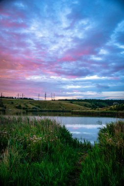 Gün batımının güzel bir görüntüsü. Sudaki bir gölün yansıması.