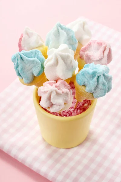 Marshmallow cake pops on pink background. Party dessert