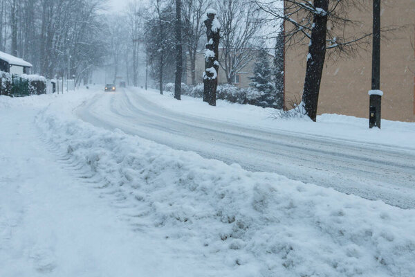 A heavy blizzard and snow on the road in Rabka Zdroj, Poland.