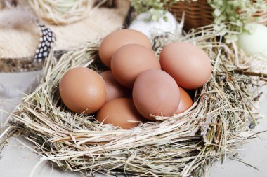 Seramik tavuk heykelcikleri, yumurtalar ve yeşil çiçeklerle şirin Paskalya süsleri. Şenlikli parti dekorasyonu