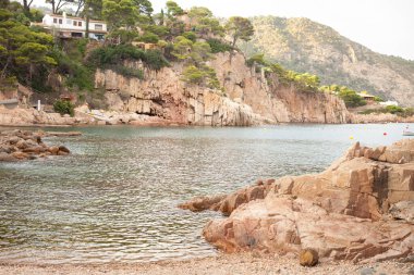 Private house on the Mediterranean seashore. Perfect seaside hike places in Spain with magnificent views with mountains and wild beaches to enjoy the sun and swimming during the summer. Travelling concept. 