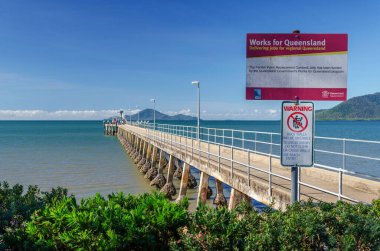 Pier and sunny sky in Cardwell town in Queensland, Australia. Cardwellis coastal town and rural localityin Cassowary Coast Region. clipart