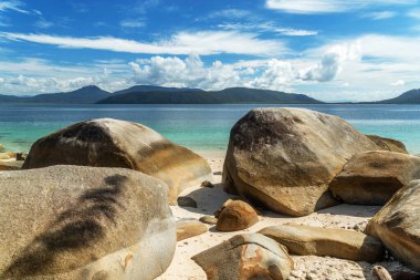 Picturesque tropical coral beach with boulders and turquoise water on Fitzroy Island. It is a continental island southeast of Cairns, Queensland, Australia. clipart