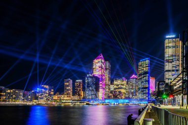 Sydney şehir manzarası ve merkez iş bölgesi hakkında aydınlatılmış gece görüşü. Sydney, Yeni Güney Galler ve Avustralya 'nın başkenti ve en büyük şehridir..