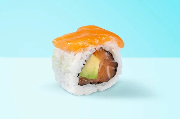 traditional japanese cuisine, japanese sushi, maki sushi with salmon on a blue background
