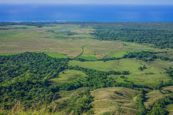 View of the coastline of the Atlantic Ocean on the island of Haiti. Green coastline turns into ocean