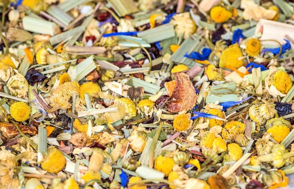 Alpine Field. Herbal tea with lemongrass, flowers and camomile. Top view. Close up. High resolution. Alpine herbs tea as background
