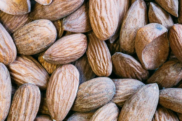 Almond nuts close. Background of almond nuts. Pile of almonds close-up as background.