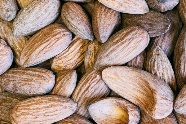 Almond nuts close. Background of almond nuts. Pile of almonds close-up as background.
