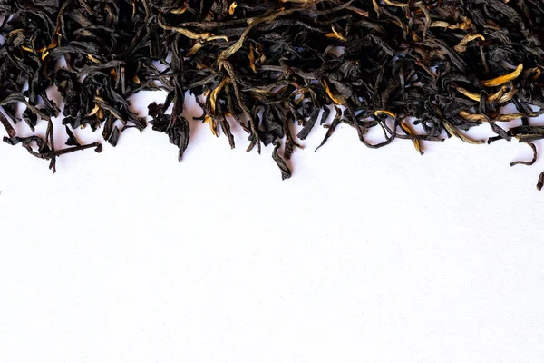Black tea on a white background.Black tea background. Black tea shot close up. Black tea macro.Top view. Close up. High resolution.