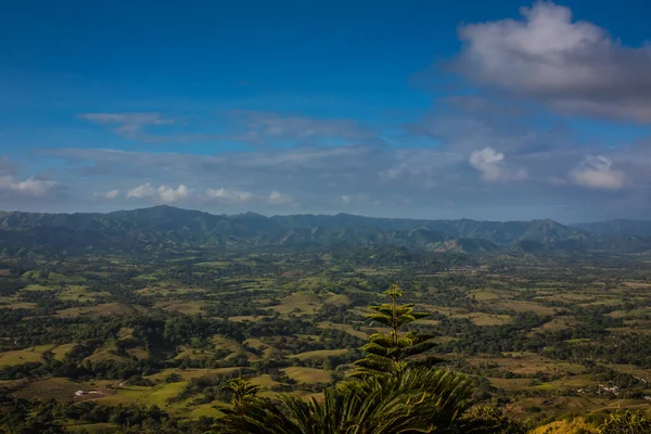 Green mountains and valleys of the island of Haiti. Blue mountains, green valley. Panoramic view of Haiti mountains in summer day. Tourism and travel concept. Natural green forest background panorama.