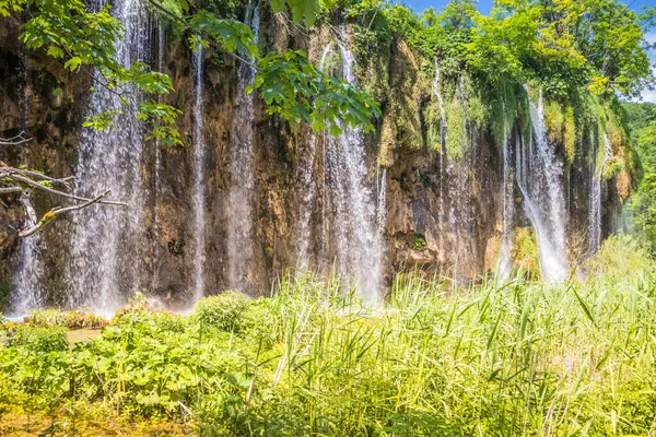 View of the beautiful picturesque waterfalls on Plitvice Lakes. Rocks and green trees around lakes with blue water. Breathtaking view in the Plitvice Lakes National Park .Croatia