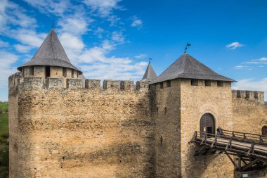Hotin Kalesi 'nin nehir kenarındaki manzarası. Khotyn Kalesi - Sarı sonbahar tepelerindeki ortaçağ kalesi. Ukrayna, Doğu Avrupa. Orta Çağ 'ın mimarisi..