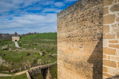 Hotin Kalesi 'nin nehir kenarındaki manzarası. Khotyn Kalesi - Sarı sonbahar tepelerindeki ortaçağ kalesi. Ukrayna, Doğu Avrupa. Orta Çağ 'ın mimarisi..