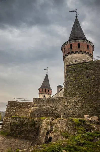 Old Kamianets-Podilskyi Castle under the cloudy sky. Part of the powerful bastions of the castle. The fortress located among the picturesque nature in the historic city of Kamianets-Podilskyi, Ukraine