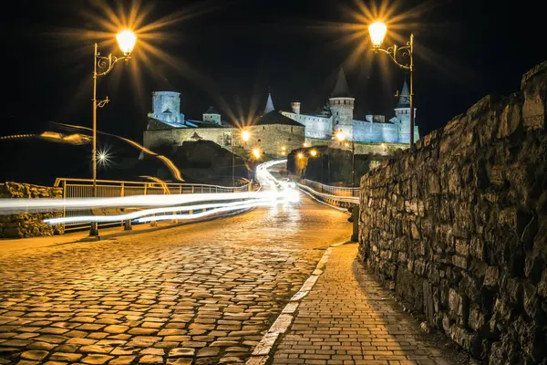 View on the Kamianets-Podilskyi castle in the night. Beautiful stone castle on the hill at night. Long exposure. Illumination of the castle. Ukraine