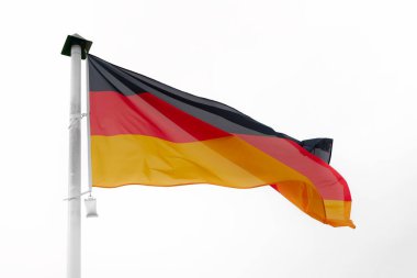   German flag waving in the wind on a flagpole with a white background                              