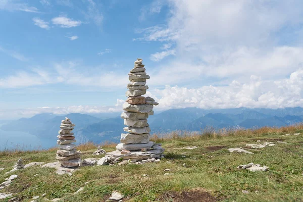 Piles of stones piled up by hikers on the summit of Monte Baldo on Lake Garda near Malcesine in Italy