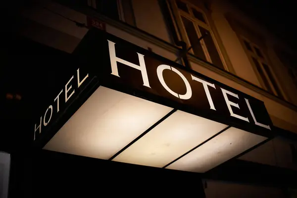 Illuminated sign of a hotel in the city center of Prague at night