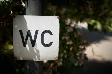 Sign for a public toilet on a public road in Germany                               