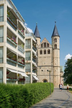 Magdeburg, Germany  June 18, 2023: City view of Magdeburg in Germany with a residential building and the Convent of Our Lady, unser lieben Frauen, in the background                               