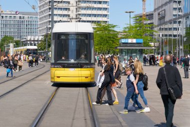   Berlin, Germany  May 30, 2023: Passers-by and streetcar as a means of public transportation at Alexanderplatz in Berlin                             