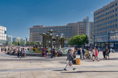  Berlin, Germany  May 30, 2023: People at the fountain on Alexanderplatz, a popular meeting place in the german capital Berlin                              