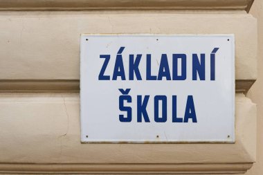 Sign with the Czech inscription Zakladni Skola, in the city center of Prague. Translation: Elementary school                                clipart