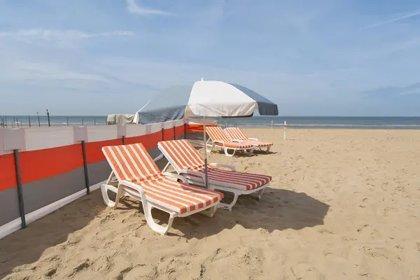 stock image   Parasol and beach chair on the North Sea beach near De Haan in West Flanders, Belgium                             