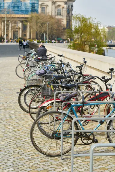 stock image   Berlin, Germany  March 31, 2024: parked bicycles and passers-by on the Humboldt Promenade at the Humboldt Forum on the banks of the Spree in Berlin                             