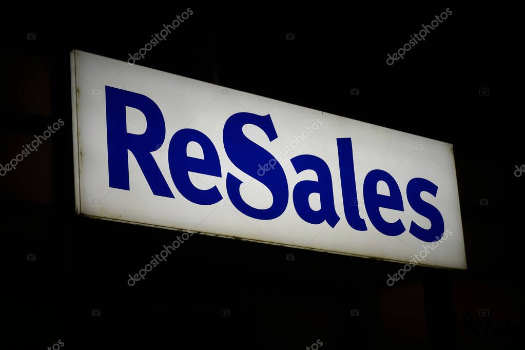 Magdeburg, Germany  February 24, 2024: Illuminated advertisement of the largest German provider of second-hand fashion ReSales in the evening in Magdeburg