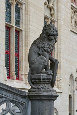 a lion, the heraldic animal of Flanders, in front of the Provincial Palace, Provinciaal Hof in the old town of Bruges in Belgium                                clipart