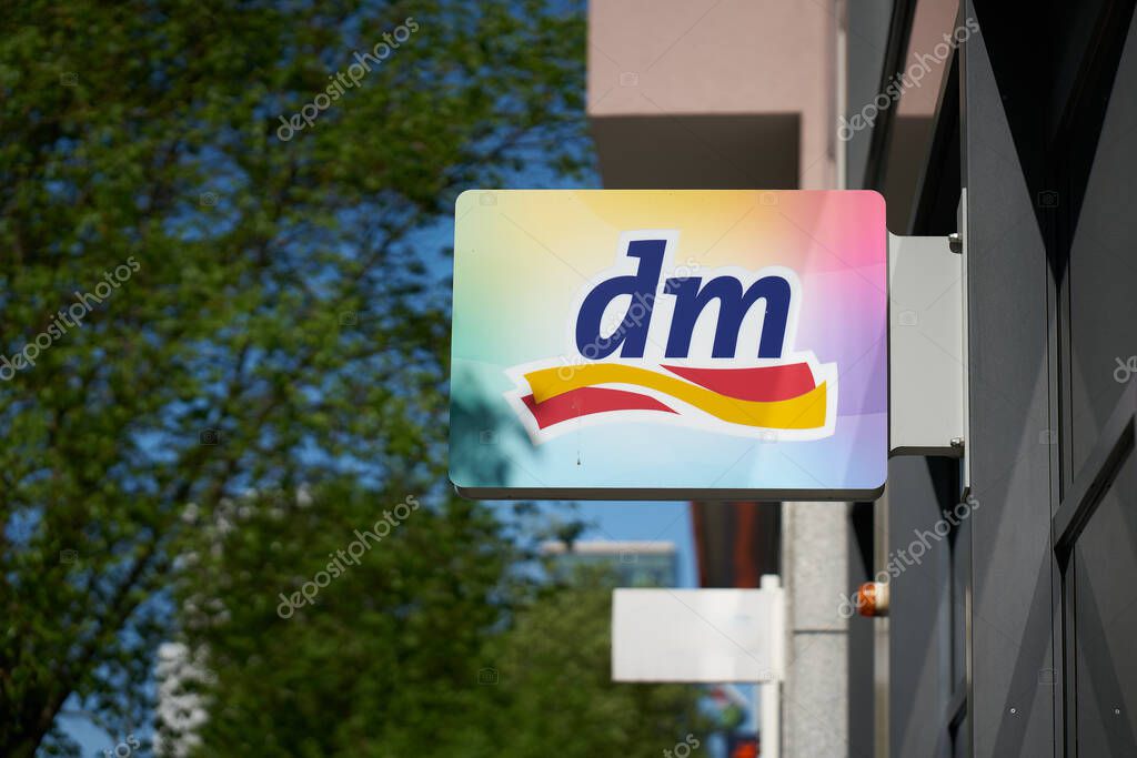 Berlin, Germany  May 01, 2025: Illuminated sign and company logo of the German drugstore chain dm in the city center of Berlin