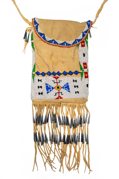 Bag of the North American Indians. Made from deerskin embroidered with colorful glass beads and leather cords isolated on white