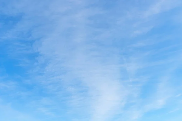 soft blue sky background with light veil clouds