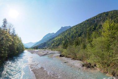 rissbach river in the karwendel mountains at springtime, view to the tirolean alps