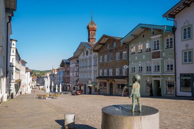 BAD TOLZ, BAVARIA, GERMANY, June 12th, 2022 - Pedestrian area in the historic old town, market place with fountain and various stores clipart