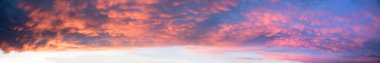 colorful wide sunset sky panorama background with mammatus clouds, orange and purple colored clipart