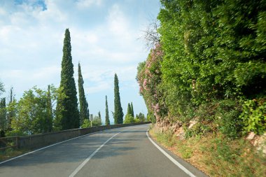 Limone ve Toscolano, İtalya 'nın batısındaki Gardesana kavşağında. Selvi ağaçları ve yol kenarındaki zakkum.