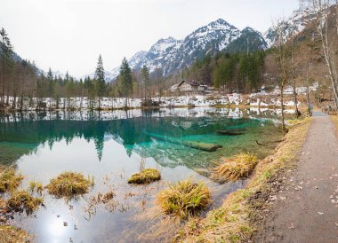 Alp lokantası bozkırı Christlessee Gölü, ilkbaharın başlarında allgau Alpleri. Biraz karlı bir manzara. su yansıması