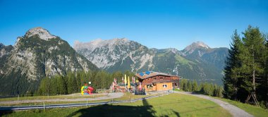 alpine hut with playground at Zwolferkopf mountain, tourist resort Pertisau, tyrol. austrian landscape in autumn clipart