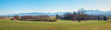 landscape alpine foothills, bavarian alps, near Kirchdorf village, upper bavarian panorama, early in the year. clipart