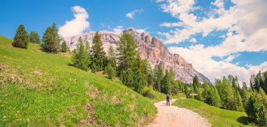 hiker at Heiligreuzkofel mountain round trail, stunning alpine landscape south-tyrol dolomites alps clipart