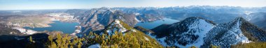 wide winter landscape upper bavarian alps, view from Herzogstand summit, lake Kochelsee and Walchensee, mountain peaks and valleys.