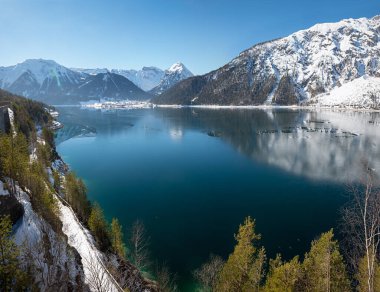 beautiful view to lake Achensee, winter landscape austria, blue-green water with frost and snowy mountains clipart