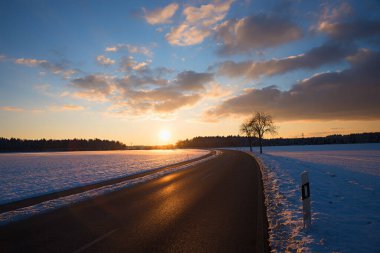 country road and bike way to Brunnthal village, sunset scenery in winter, landscape upper bavaria clipart