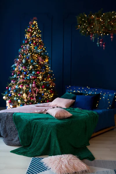 クリスマスの装飾 大きなベッドと暗い色のベッドルーム 内装はガーランドとクリスマスツリーで飾られています モダンなスタイル 居心地の良いクリスマスホームインテリア — ストック写真