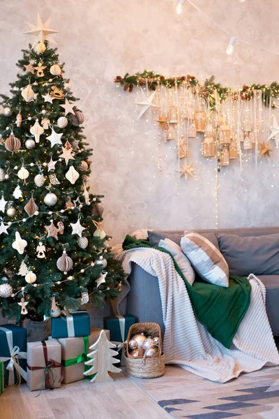 クリスマスツリーやギフトで飾られた快適なソファ付きのモダンなスタジオリビングルームのインテリア 垂直画像 — ストック写真